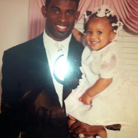 Deiondra Sanders with her father Deion Sanders during her early age. 
