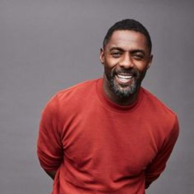 Idris Elba, Winston Elba's father smiling on a photoshoot.