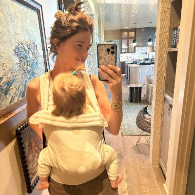 Katherine, holding her daughter, Eloise, while taking a mirror selfie.